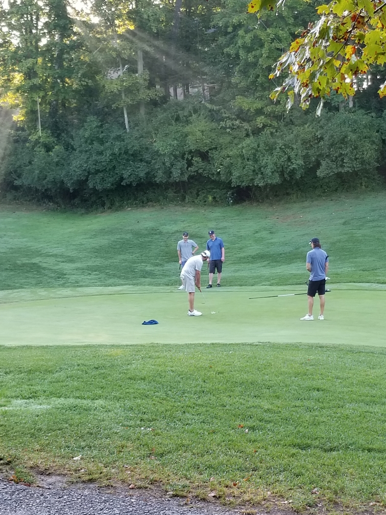 Golfers on the putting green at Aston Oaks Golf club