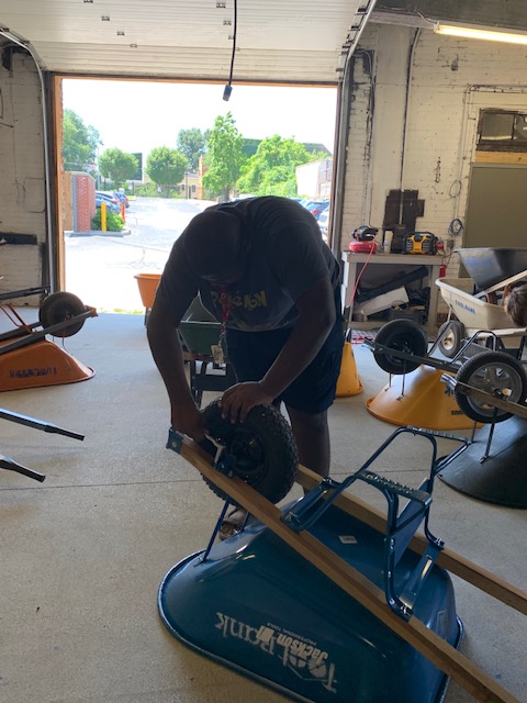 Youth assembling wheelbarrow at Toolbank