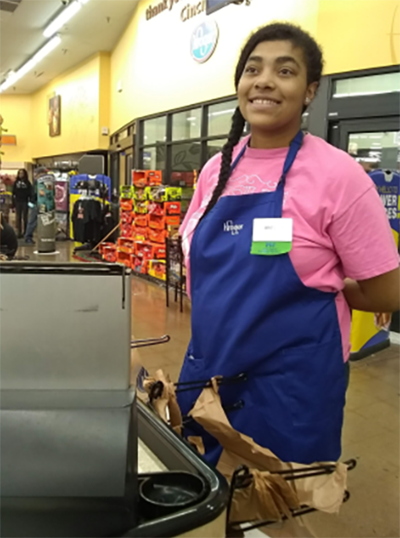 Graduate of the job development program enjoying her job at Kroger